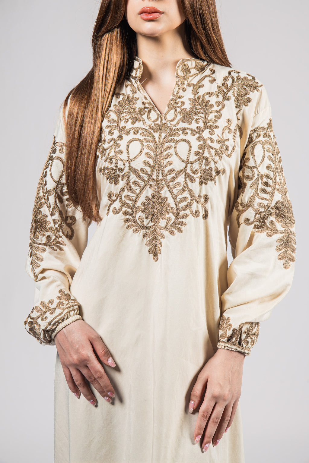 The Desert Bloom Abaya is crafted from lightweight, breathable cotton, making it the perfect choice for all-day comfort. Its beauty is elevated by intricate embroidery that traces delicate patterns across the fabric.  Has a belt from the back to make the abaya tight or loose under the bust.